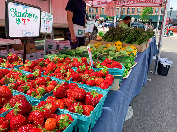 Strawberries on table in front of vegetables