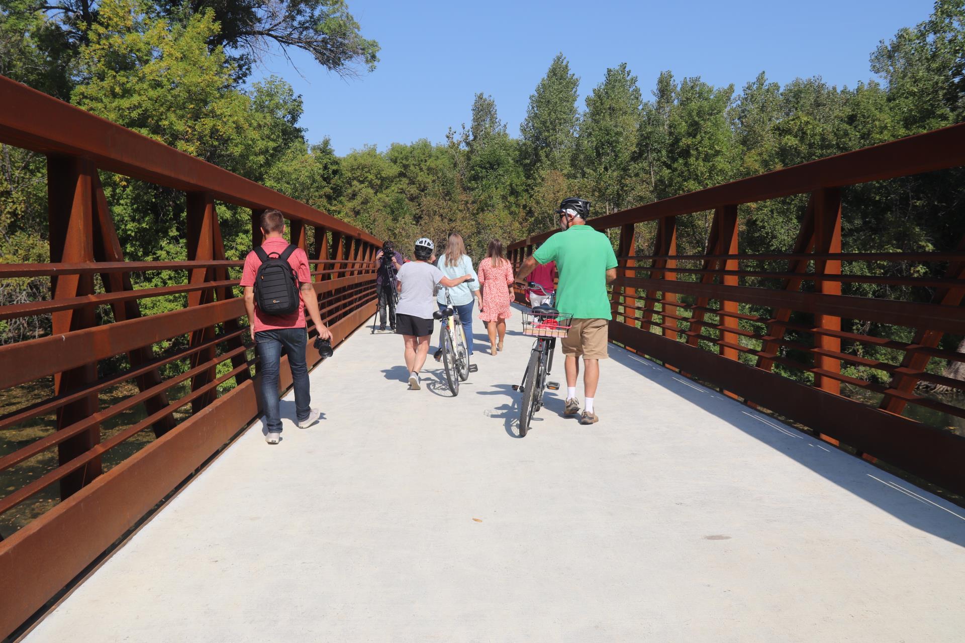 Bikers and walkers cross the bridge after the ribbon cutting