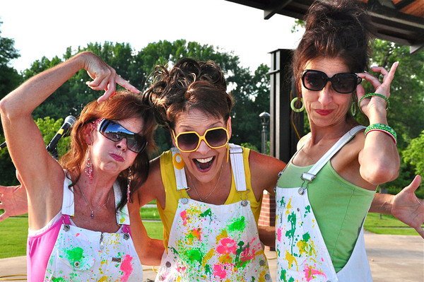 Three women dressed in colorful outfits