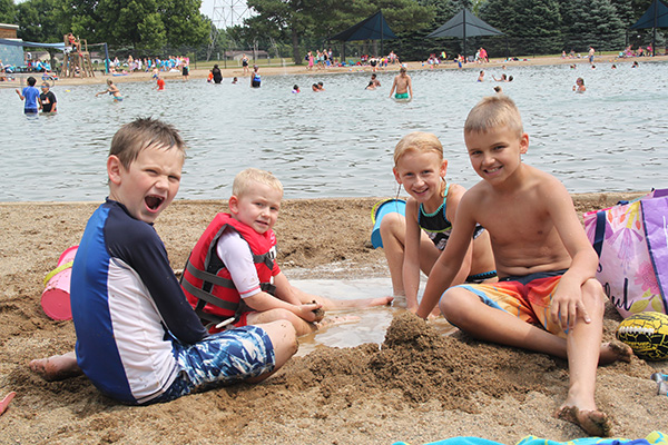 Four kids playing in sand