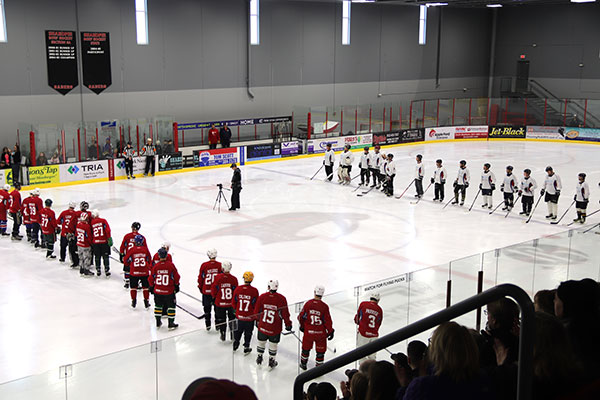 Hockey players line up before the game